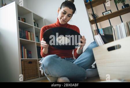 Playing vinyl records. Listening music, leisure time, staying home Stock Photo