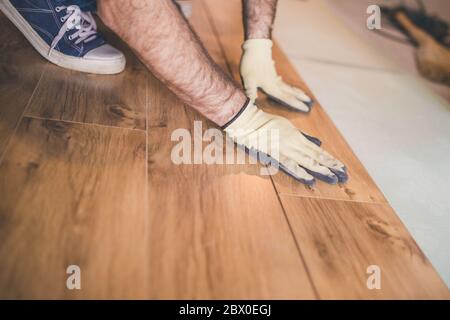 Flooring technology - laying of a floating laminate floor - eco-friendly finishing material Stock Photo