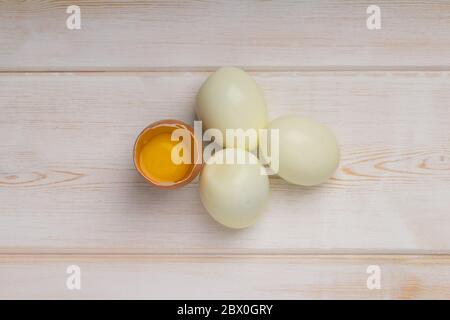 Eggs on wooden planks. Top view . boiled  abd raw egg on wooden background Stock Photo