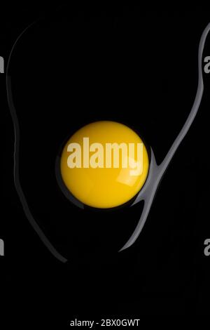 Top view of broken egg on black background Stock Photo