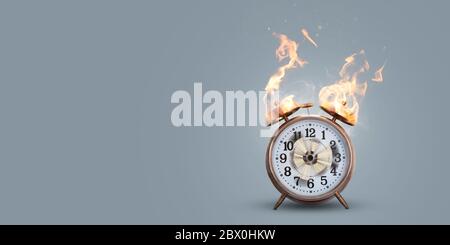 Out of time concept - clock on fire with actual flame Stock Photo