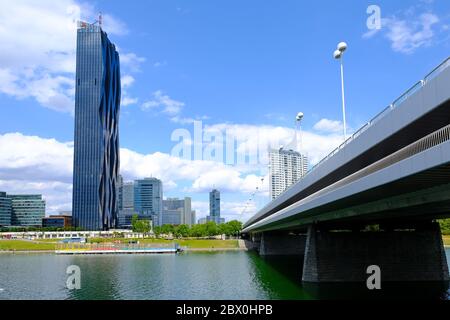 VIENNA, AUSTRIA - JULY 9, 2019: Skyline of Donau City, seen from the right bank of the Danube, near the Empire Bridge. DC-Tower is the tallest skyscra Stock Photo