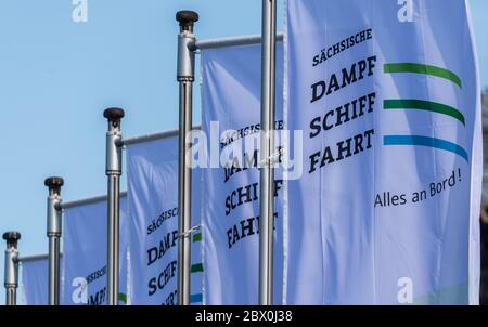 Dresden, Germany. 03rd June, 2020. Flags of the Sächsische Dampfschiffahrt are waving in the wind on the terrace bank. The Sächsische Dampfschiffahrt Dresden (SDS) has filed for insolvency. The background to this are financial difficulties, for which the SDS last week blamed the missing tranche of a loan from the Free State. The 'White Fleet' operates with nine paddle steamers built between 1879 and 1929 as well as two modern passenger ships and is considered the oldest and largest fleet of paddle steamers in the world. Credit: Robert Michael/dpa-Zentralbild/dpa/Alamy Live News Stock Photo