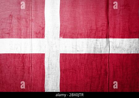 National flag of Denmark depicting in paint colors on an old brick wall ...