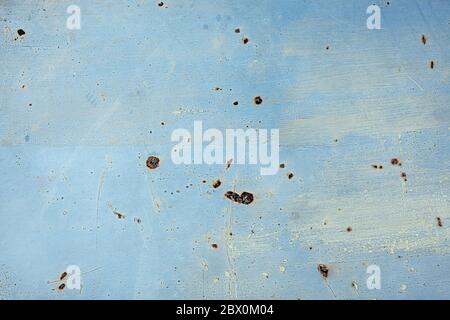 metall wall with rusty spots and gray yellow paint strokes on blue Stock Photo