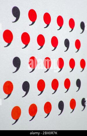 black comma in many red commas. Stock Photo
