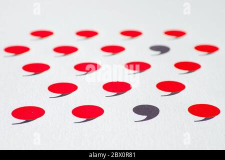 black comma in many red commas. Stock Photo