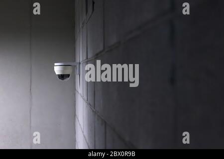 a security camera installed on a concrete wall. Stock Photo