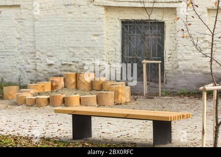 Wooden bench in yard against facade of old building in town Stock Photo