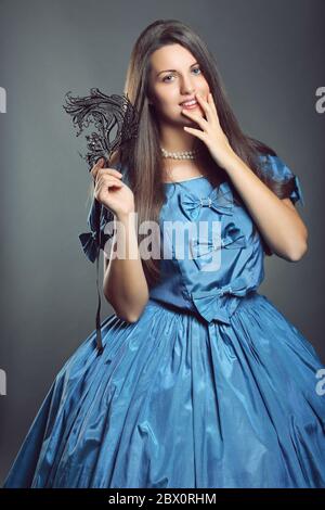 Beautiful woman in blue princess dress with black mask . Venice carnival portrait Stock Photo