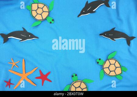 Marine biodiversity concept. Sea animals cutout in blue sea background with copy space. Top view, flat lay. Stock Photo