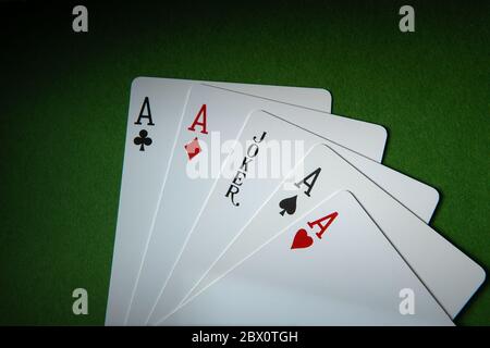 Joker card and four A cards. Stock Photo
