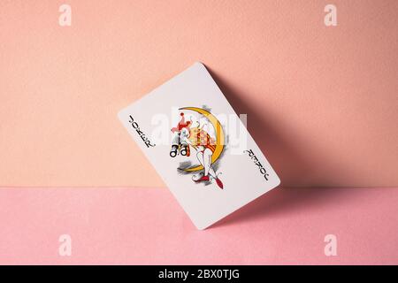 Joker playing card on pink background. Stock Photo