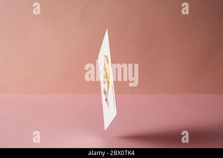 Joker playing card on pink background. Stock Photo