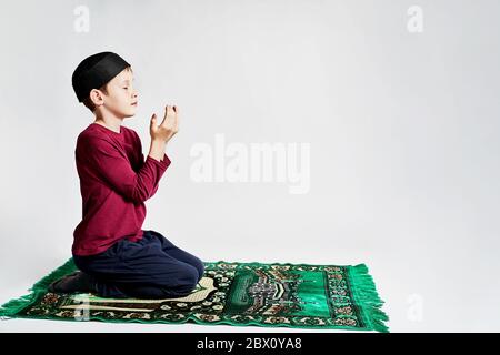 a Muslim boy makes a prayer on the Ramadan holiday Stock Photo