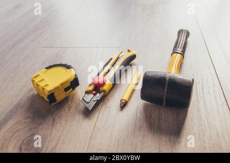 Tools for laying laminate - knife, tape measure, hammer and pencil Stock Photo