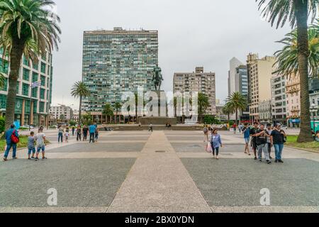 Tourists passing the statue of General Artigas on the Independance square (Plaza Indepencia), Montevideo, Uruguay, January 25th 2019 Stock Photo