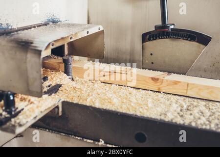 Planing of a bar in the industrial machine - production of a glued bar Stock Photo