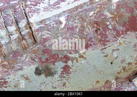 background, old car body, peeled off paint in white, red and green, rust and scratches Stock Photo