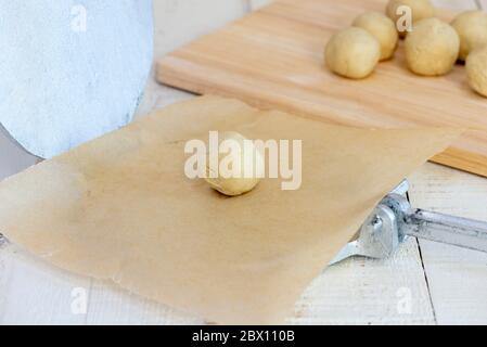 Making authentic corn tortillas - small ball of tortilla dough on tortilla press. Stock Photo