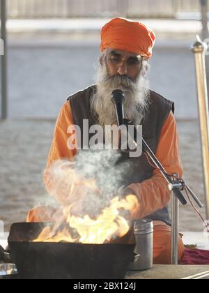 Bishnoi Priest undertaking fire ceremonyJajiwal Dune Rajasthan, India PE000028 Stock Photo