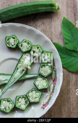 Ladyfinger pieces on plate during daylight Stock Photo