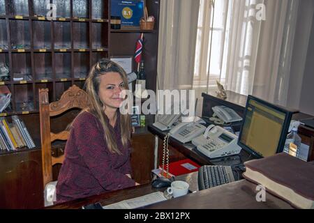Becej, Fantast Castle, Serbia May 19, 2020. A smile of a young woman receptionist in a castle hotel while it is a moment of break and rest. Stock Photo