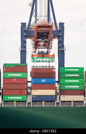 A crane unloads cargo from a ship Stock Photo - Alamy