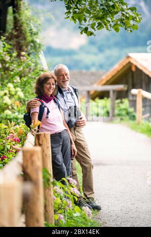 A senior pensioner couple with binoculars hiking, resting. Copy space. Stock Photo