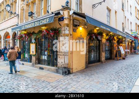 Lyon, France 3rd January 2020 - tourists passing a traditional Bouchon Lyonais (homecook restaurant) in the old part of Lyon Stock Photo