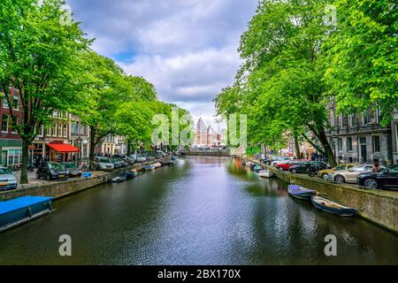 Amsterdam May 18 2018 - The Kloveniersburgwal channel with in the background the Nieuwmarkt square and the old Waagh building (scale house) Stock Photo