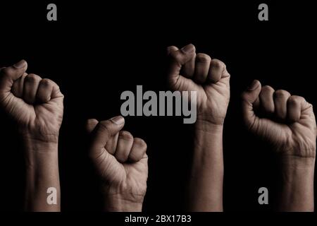 Concept against racism or racial discrimination by showing with hand gestures fist or solidarity Stock Photo