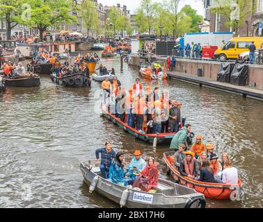 Amsterdam, The Netherlands, April 27 2018, Tourists and locals sailing on the Prinsengracht to celebrate Kingsday Stock Photo