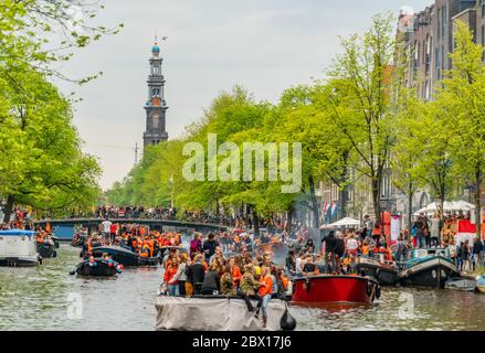 Amsterdam, The Netherlands, April 27 2018, Tourists and locals sailing on the Prinsengracht to celebrate Kingsday Stock Photo