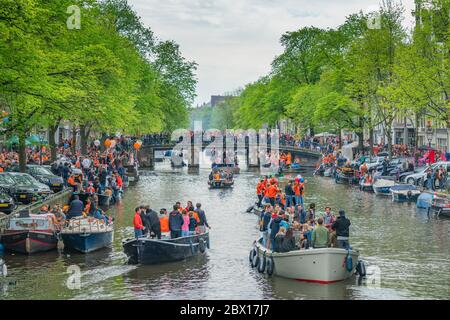 Amsterdam, The Netherlands, April 27 2018, Tourists and locals sailing on the Prinsengracht to celebrate Kingsday Stock Photo