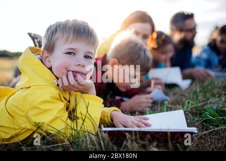 Group of school children with teacher on field trip in nature. Stock Photo