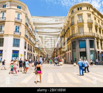 Malaga, Spain, june 27 2017: Tourists and locals walking on the Plaza de La Marina entering the the Calle Marqués de Larios Stock Photo