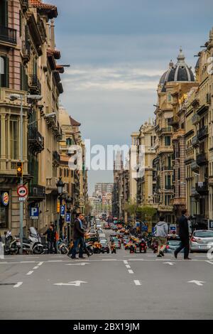 Barcelona, Spain, April 12, 2012: Street view with people crossing, and cars driving, 2012: Street view with people crossing, and cars driving Stock Photo
