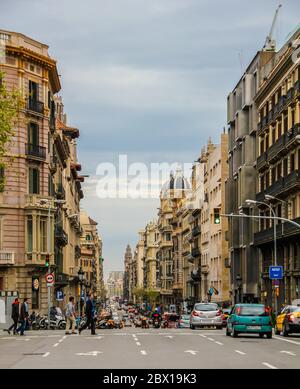 Barcelona, Spain, April 12, 2012: Street view with people crossing, and cars driving Stock Photo