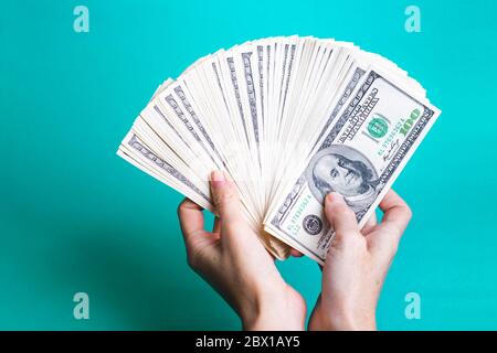girl hands holding a batch of dollars Stock Photo