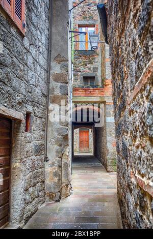 Narrow alley between houses in an old town Stock Photo