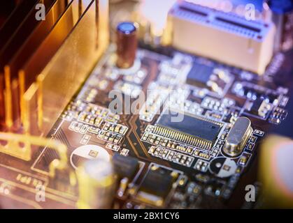 Computer motherboard background with blur neon multicolor glow Stock Photo