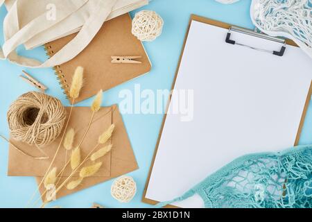 Zero waste concept. White sheet on clipboard, craft envelopes Stock Photo