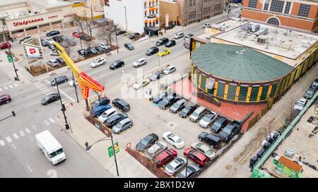 A drone / aerial view of the Hard Rock Cafe in downtown Chicago with cars driving by and a Walgreens store in the background. Stock Photo