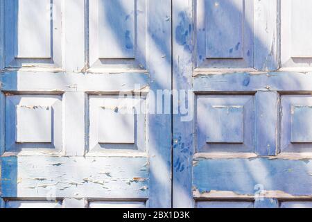 Blue door with squre pattern and peeling paint Stock Photo