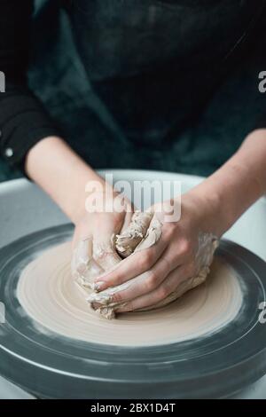 Woman making ceramic pottery on wheel, hands close-up, creation of ceramic ware Stock Photo