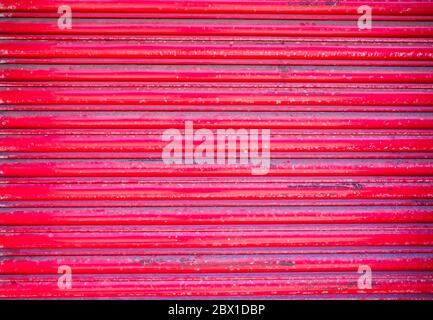 red roller shutter on the door of closed retail premises Stock Photo