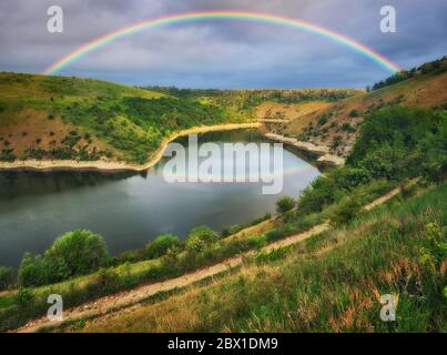 colorful rainbow over river canyon Stock Photo