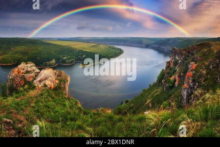 colorful rainbow over river canyon Stock Photo