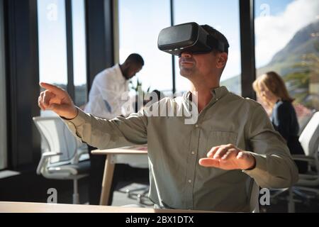 Business people using VR headset Stock Photo